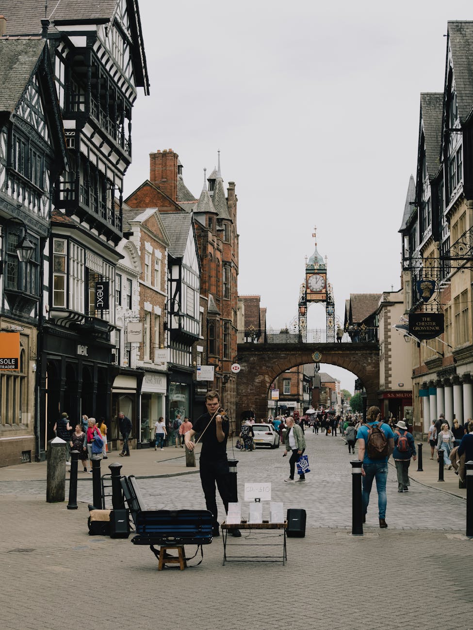 man playing violin in a city